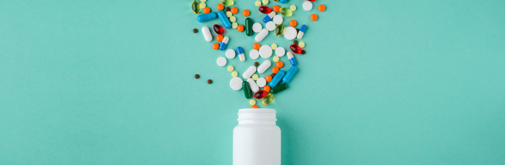 Various medications and vitamins, a pill bottle.