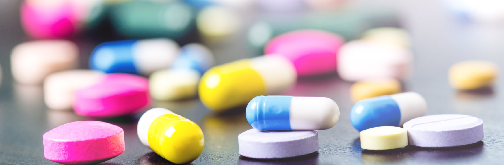 tablets and pills on a black table