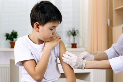 boy and vaccine syringe